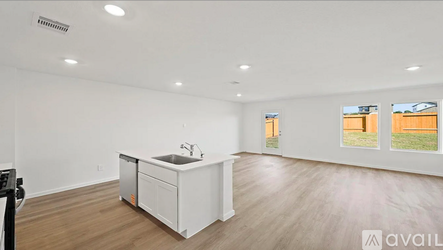 A kitchen with white cabinets and a sink is available for rent.