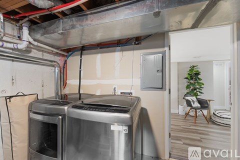 A kitchen area with a stainless steel oven and a wall-mounted cabinet.