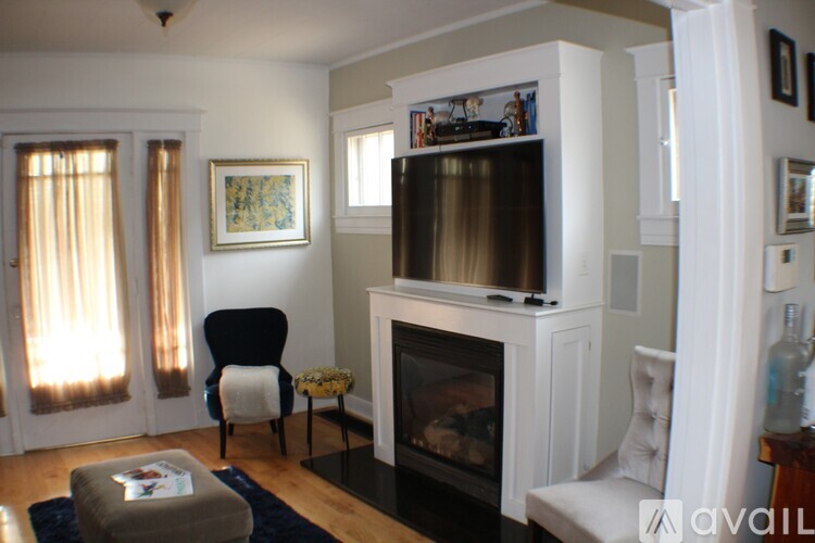 A living room with a fireplace and a chair.