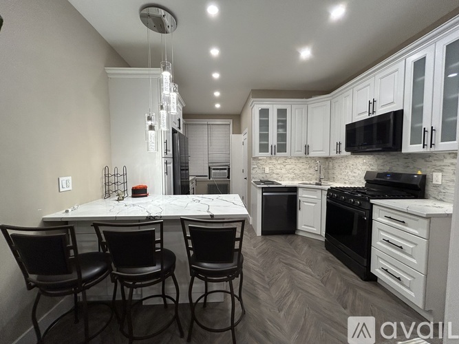 A modern kitchen with a dining table and chairs.