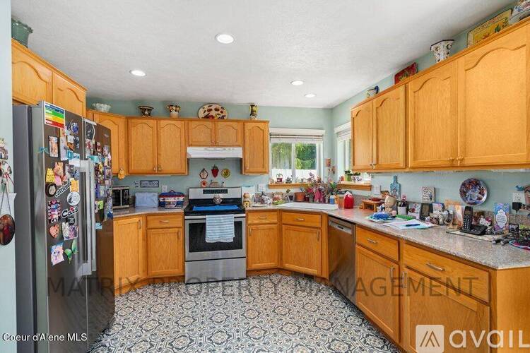 A kitchen with wooden cabinets and a patterned floor.