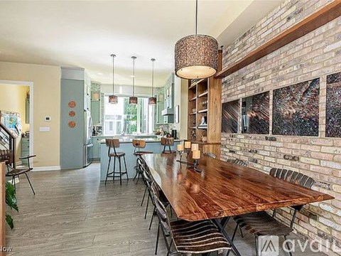 A dining area with a long wooden table and chairs.