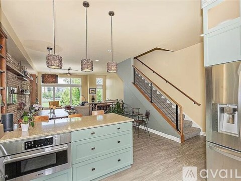 A kitchen with a stainless steel refrigerator and a stainless steel oven.