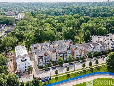 A bird's eye view of a residential area with houses and a pool.