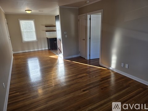 A room with wooden floors and a window.