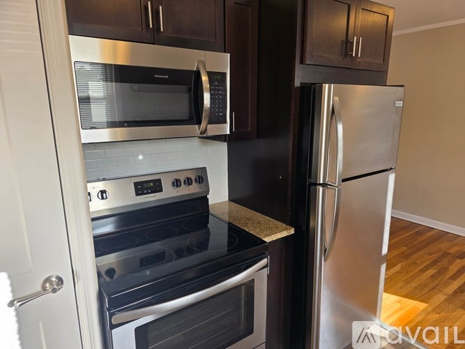 A kitchen with a stainless steel refrigerator and oven.
