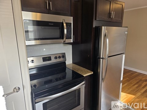 A kitchen with a stainless steel refrigerator and oven.