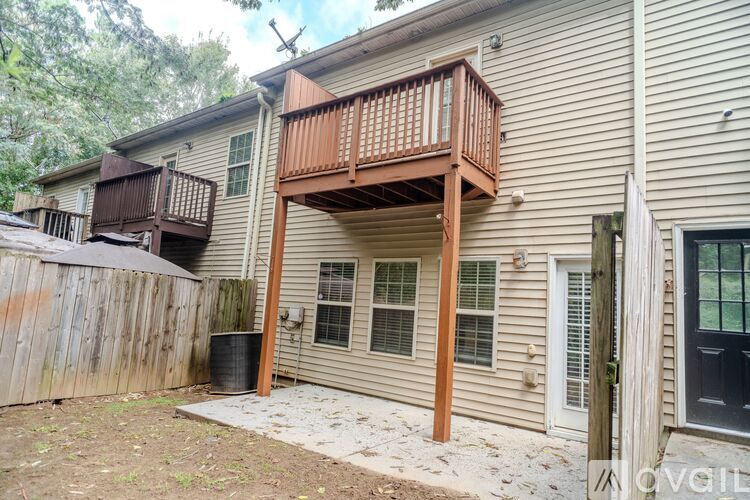 A house with a deck and a fence.
