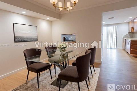 A modern dining room with a glass table and chairs.