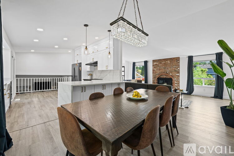 A modern dining room with a wooden table and chairs.
