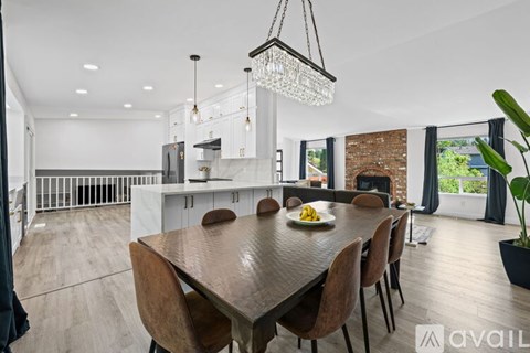A modern dining room with a wooden table and chairs.