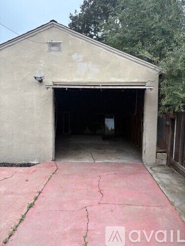 A concrete building with a garage door open.