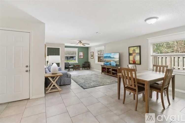 A dining room with a table and chairs.