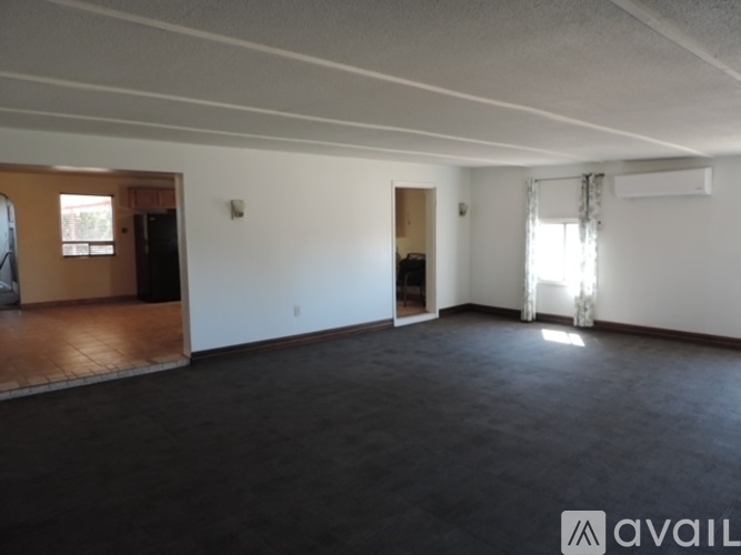 A spacious room with a door and a window.