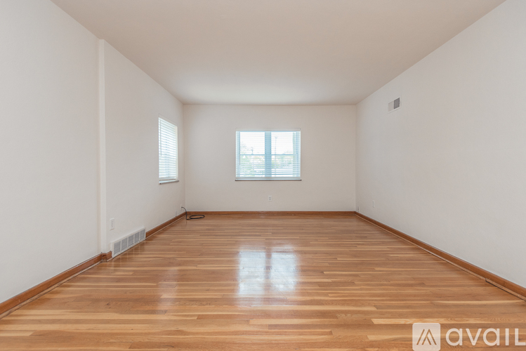 A room with wooden flooring and a window.