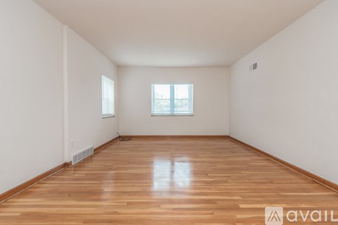 A room with wooden flooring and a window.