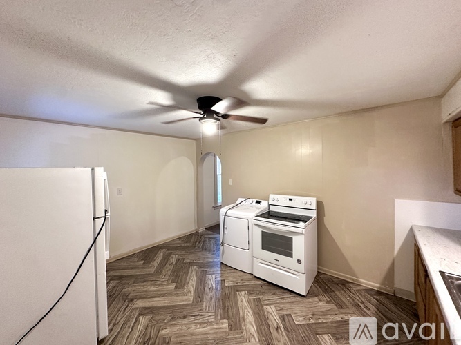 A kitchen with a white fridge, stove and oven.