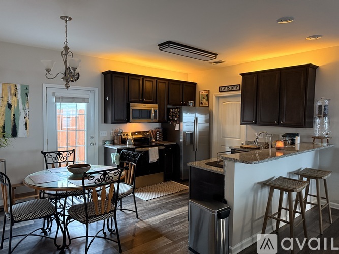 A kitchen with a table and chairs in the middle of the room.