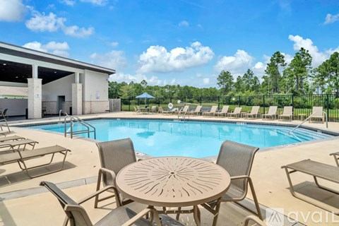 A pool area with a table and chairs is available for use.