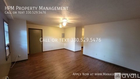 A room with HPM Property Management written on the wall and a door.