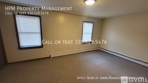 A room with HPM Property Management written on the wall and a phone number to call or text.