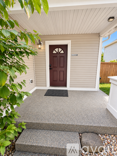 A brown door is on the front of a house.
