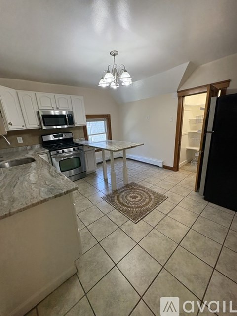 A kitchen with a granite counter top and a sink.