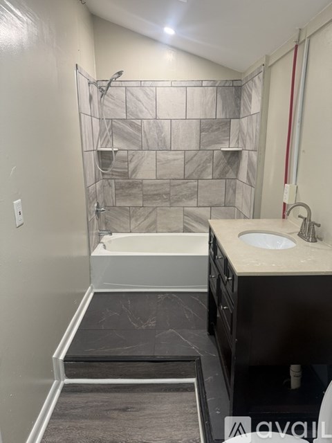 A bathroom with a walk-in shower and a sink.