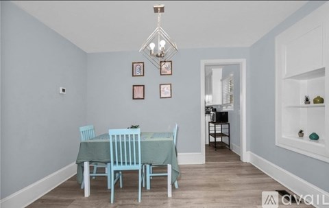 A dining room with a table set for four.