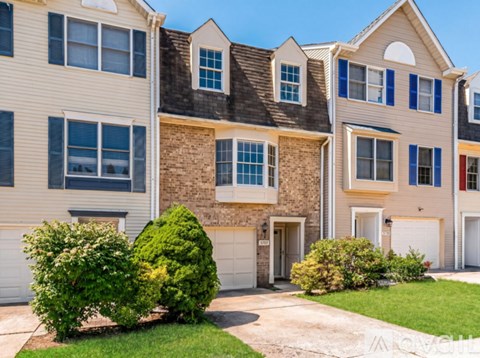 A row of houses with a mix of stone and siding exteriors.