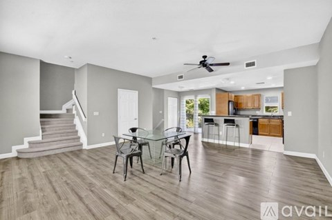 A spacious living room with a dining table and chairs.