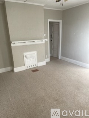 A room with a carpeted floor and a door.
