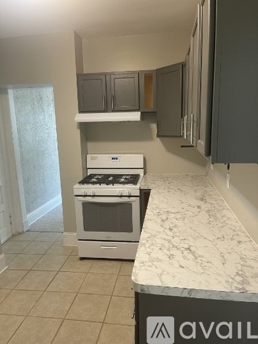 A kitchen with a stove top oven and a counter top.