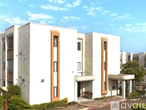A modern white building with brown doors and windows.