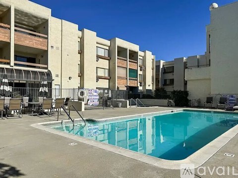 A swimming pool in front of apartment buildings.