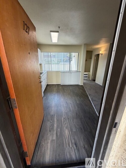 A hallway with a door numbered 127 is shown.