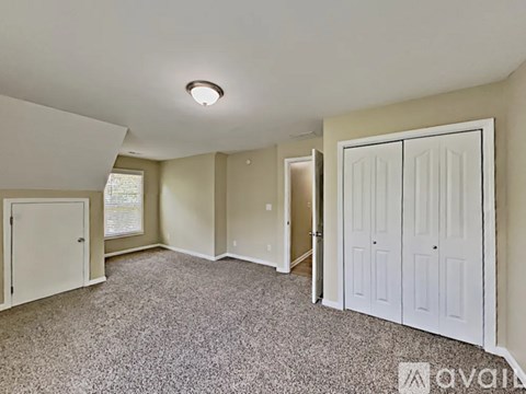 A room with a carpeted floor and white walls.