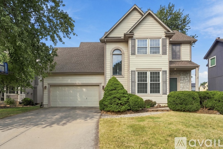 A two-story house with a garage is available for rent.