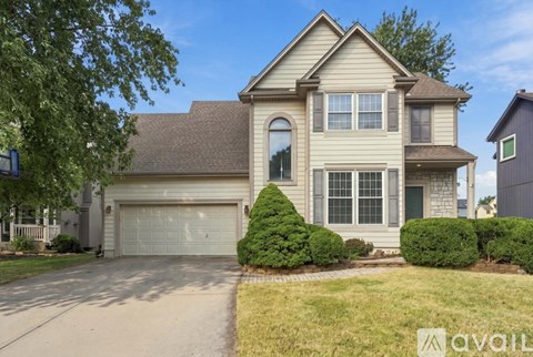 A two-story house with a garage is available for rent.