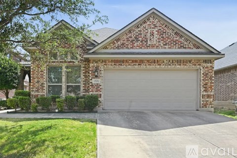 A brick house with a garage door and a driveway.