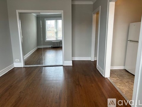 A room with wooden floors and white walls.