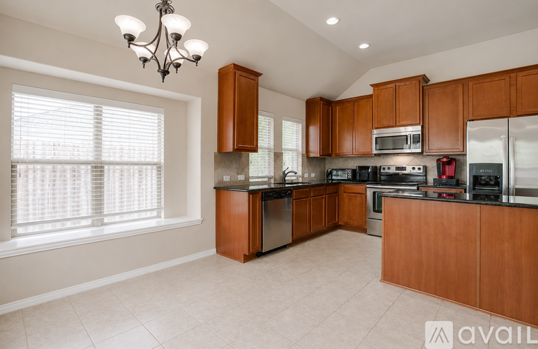A kitchen with wooden cabinets and a range hood.