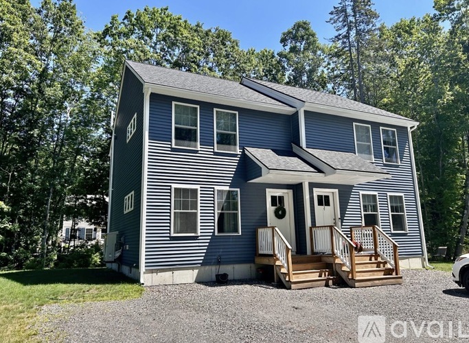 A two-story house with a front porch and a garage.
