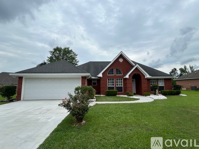 A house with a red brick facade and a white garage door.