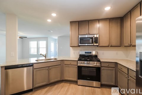 A kitchen with wooden cabinets and stainless steel appliances.