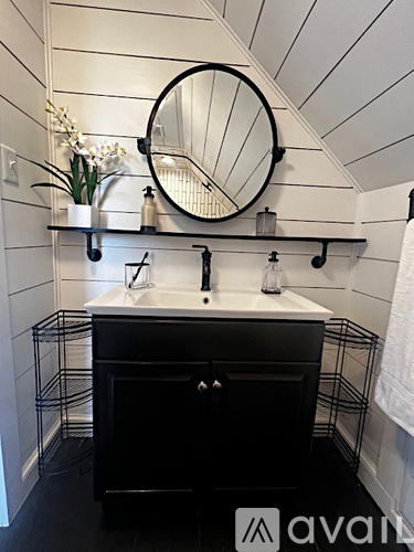 A bathroom with a sink and mirror.