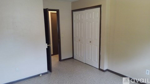 A room with a white door and a brown door.