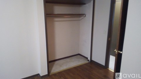 A room with a door and a mat on the floor.