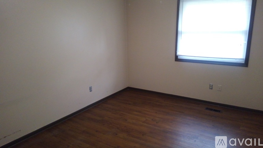 A room with wooden floors and a window.