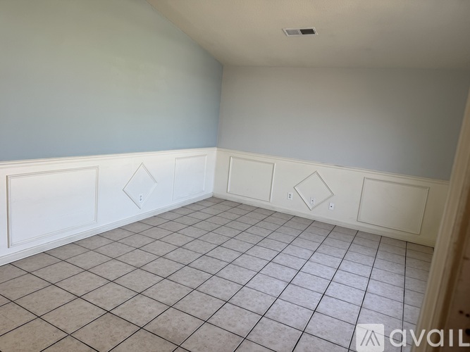 A room with white walls and a tiled floor.